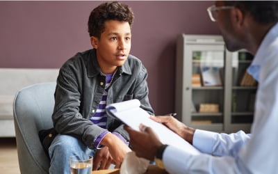 Excited Boy Talking to Psychologist